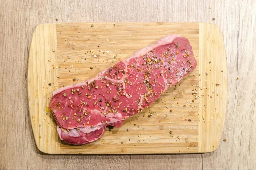 Prepared steak on cutting board